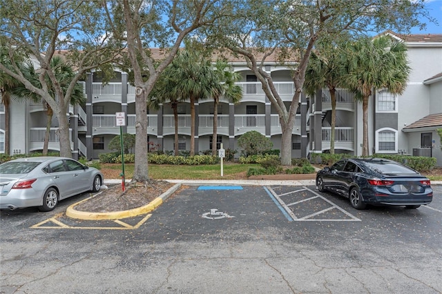 view of property featuring uncovered parking