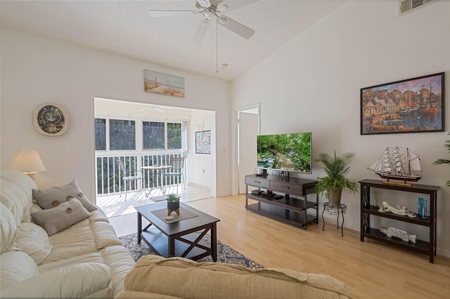 living room featuring ceiling fan, light wood finished floors, and visible vents