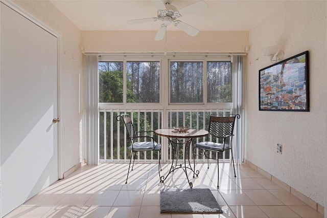 sunroom featuring ceiling fan