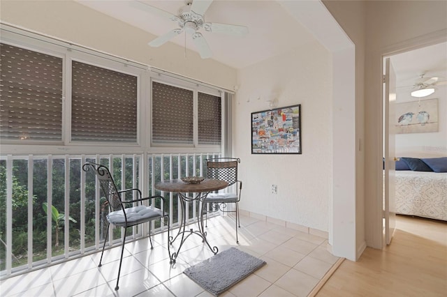 sunroom / solarium featuring ceiling fan