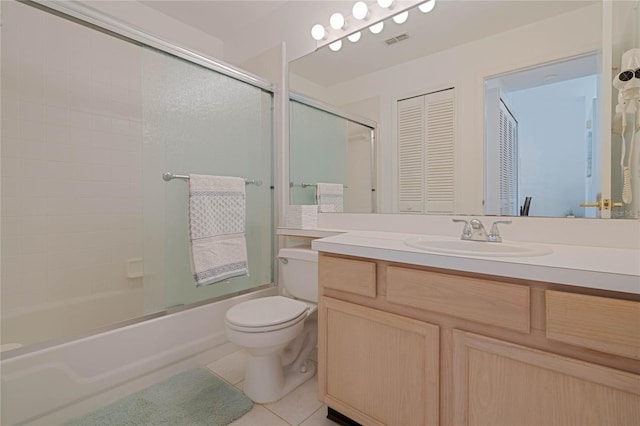 bathroom featuring enclosed tub / shower combo, tile patterned flooring, vanity, visible vents, and a closet