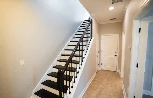 staircase with baseboards, visible vents, ornamental molding, and tile patterned floors