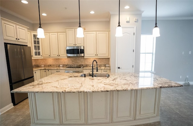 kitchen featuring a kitchen island with sink, glass insert cabinets, stainless steel appliances, and a sink