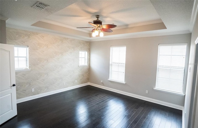 spare room featuring baseboards, a raised ceiling, visible vents, and wallpapered walls