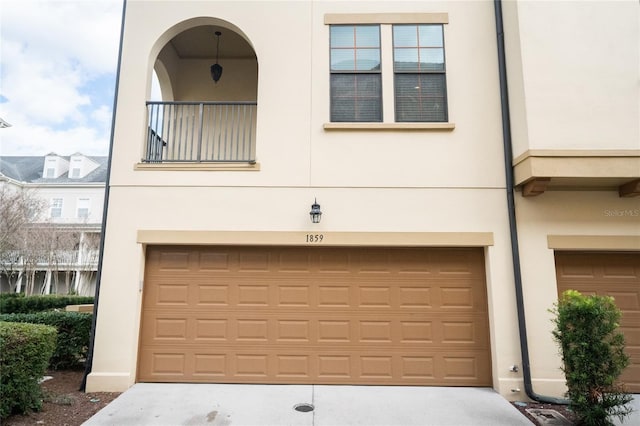 view of front of home with a garage and stucco siding