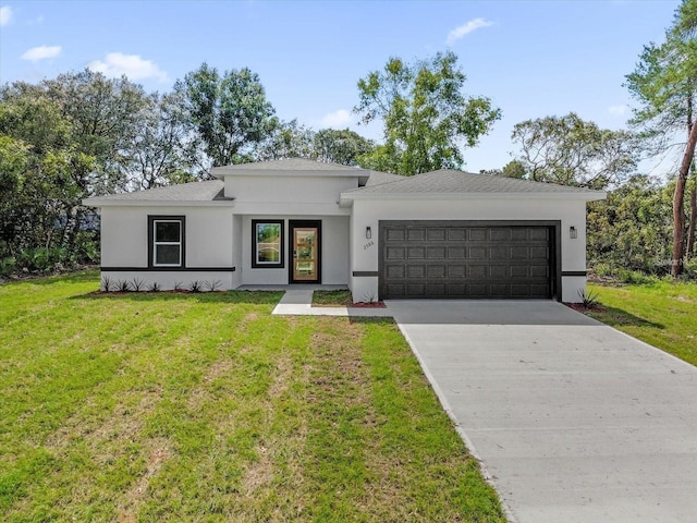 view of front of home with a garage, a front yard, concrete driveway, and stucco siding