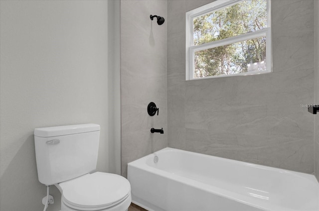 bathroom featuring toilet and bathing tub / shower combination