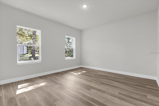 unfurnished room featuring wood finished floors and baseboards