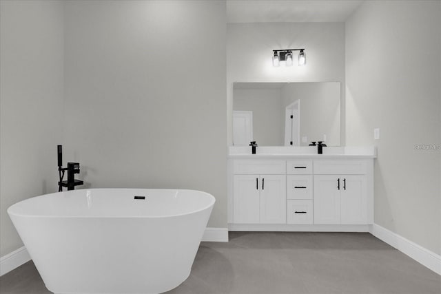 full bathroom with double vanity, a soaking tub, and baseboards