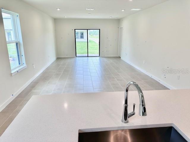 3219 Cup Dr, Lakeland, FL 33803 - unfurnished room with a sink, light tile patterned floors, healthy amount of natural light, baseboards, and recessed lighting
