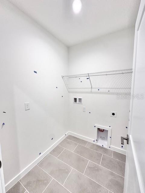3219 Cup Dr, Lakeland, FL 33803 - laundry area with gas dryer hookup, hookup for an electric dryer, hookup for a washing machine, and tile patterned flooring