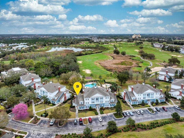 aerial view featuring a residential view, view of golf course, and a water view