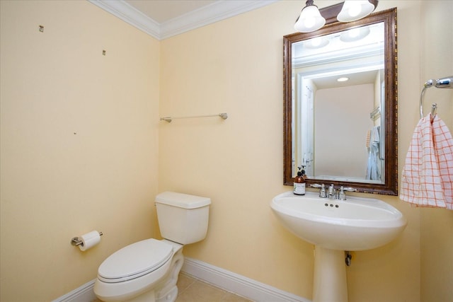 bathroom featuring baseboards, tile patterned flooring, toilet, and crown molding