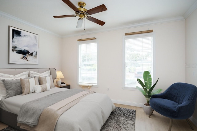 bedroom featuring ornamental molding, a ceiling fan, baseboards, and wood finished floors