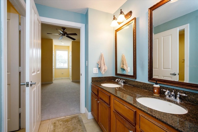 full bath with double vanity, tile patterned flooring, a ceiling fan, and a sink