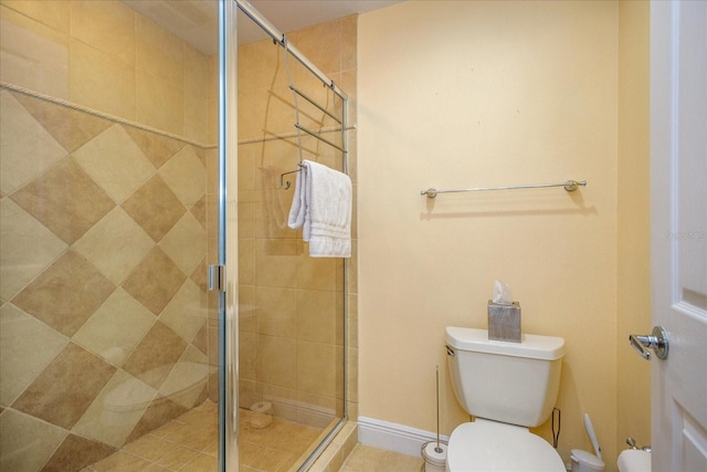 full bathroom featuring a shower stall and toilet