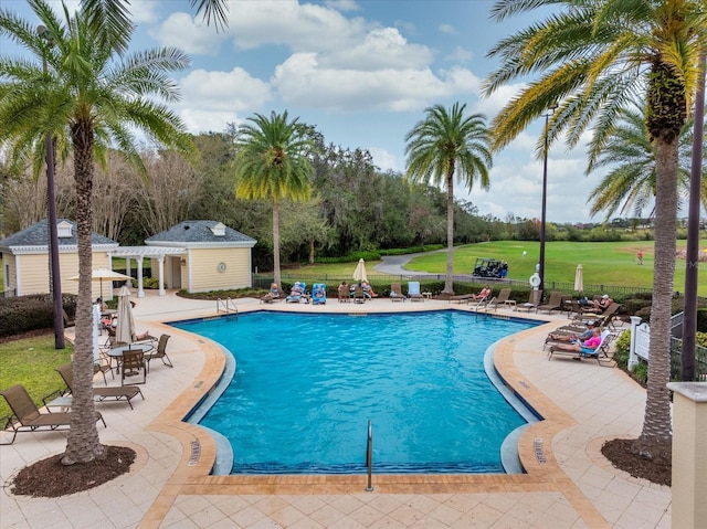 pool with a patio area and a pergola