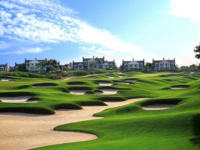 view of community featuring a residential view, golf course view, and a lawn