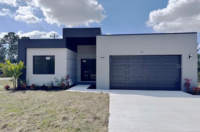 contemporary home with a garage and a front lawn