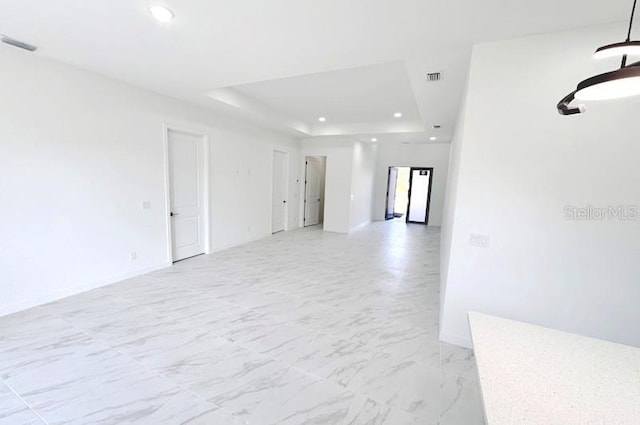 unfurnished room with a tray ceiling