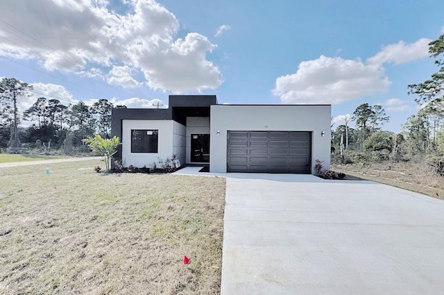 modern home featuring a front yard and a garage