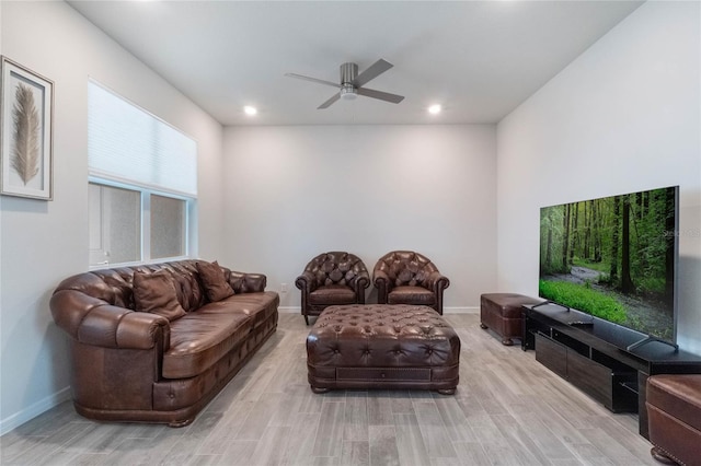 living room featuring light wood-type flooring, ceiling fan, baseboards, and recessed lighting