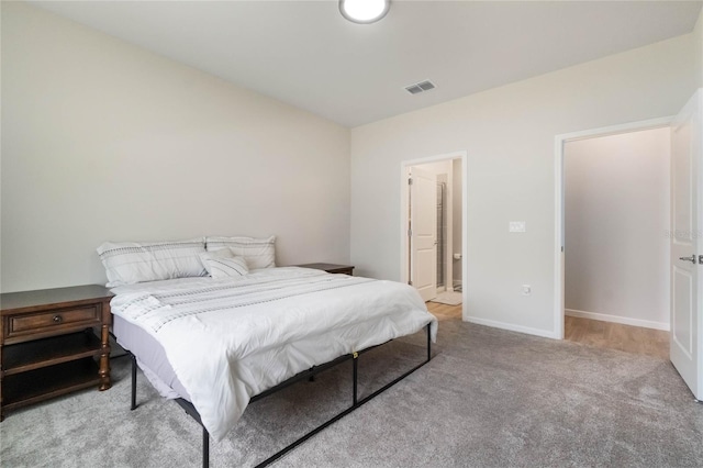 bedroom featuring light carpet, baseboards, and visible vents