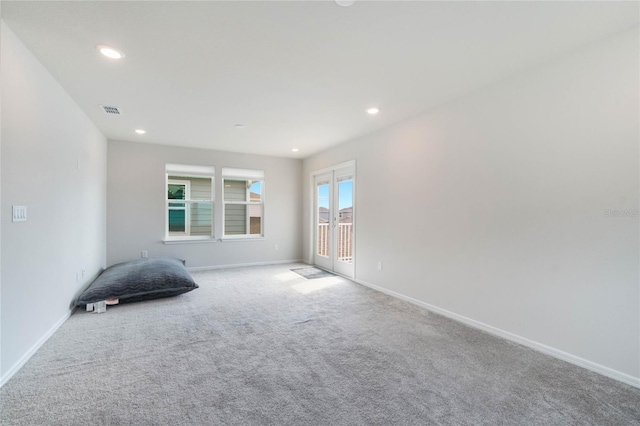 unfurnished room featuring light carpet, baseboards, visible vents, and recessed lighting