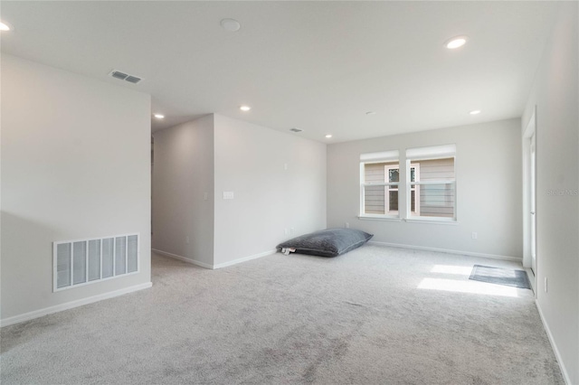 unfurnished room with light colored carpet, visible vents, and recessed lighting