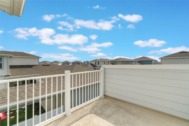 view of patio with a residential view and a balcony