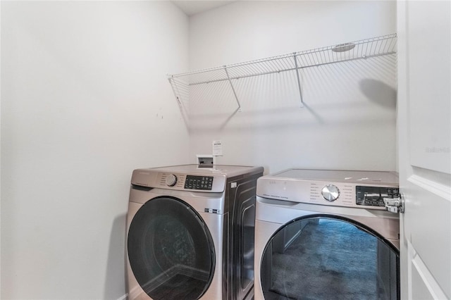 washroom with laundry area and washer and clothes dryer