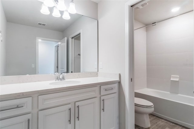 bathroom featuring shower / bathtub combination, a chandelier, toilet, vanity, and visible vents