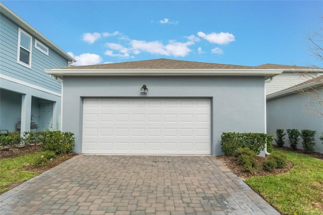 garage featuring decorative driveway