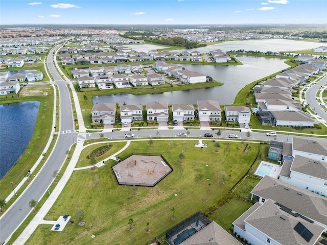 birds eye view of property featuring a water view and a residential view