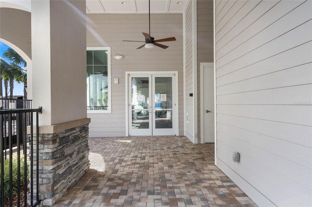 entrance to property with a patio, french doors, and a ceiling fan