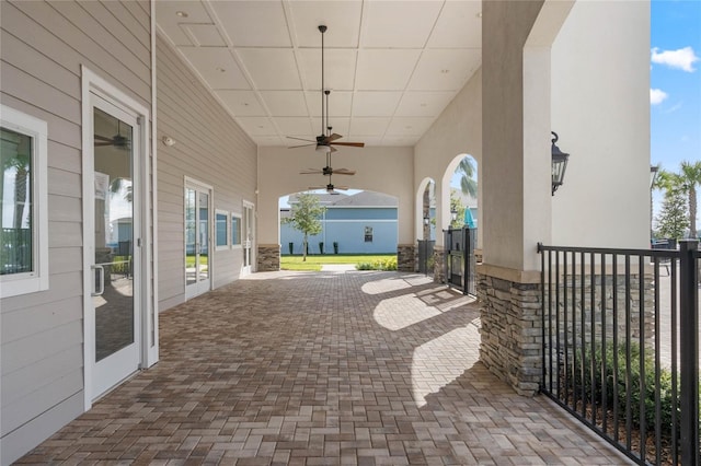 view of patio / terrace featuring ceiling fan and decorative driveway