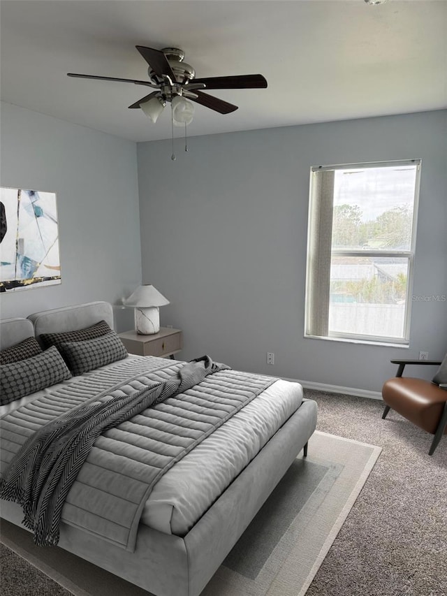 bedroom featuring ceiling fan, carpet, and baseboards