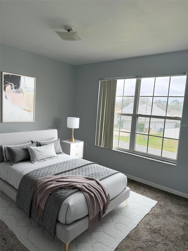 bedroom with carpet flooring and baseboards