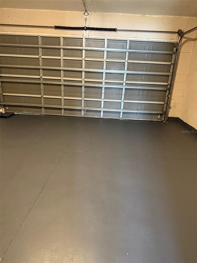 garage with concrete block wall