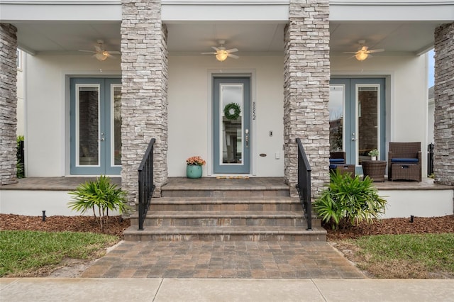 view of exterior entry featuring french doors and stucco siding