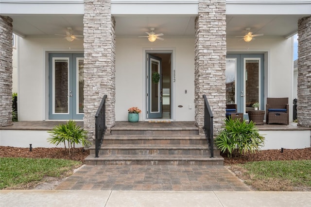 property entrance featuring covered porch, french doors, a ceiling fan, and stucco siding