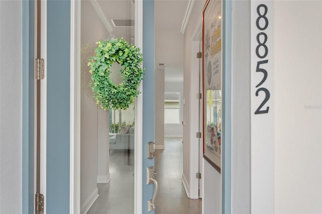 interior space featuring baseboards and ornamental molding