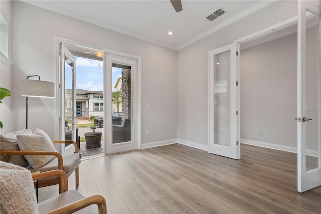 living area featuring french doors, visible vents, baseboards, and wood finished floors