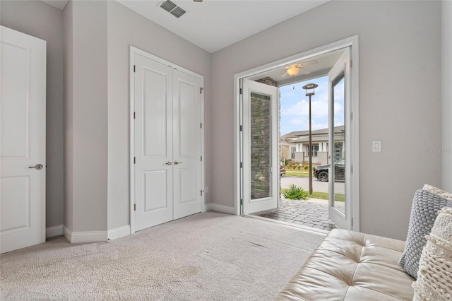 carpeted bedroom featuring baseboards, a closet, visible vents, and access to exterior