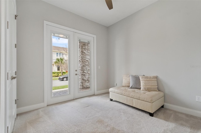 living area featuring french doors, carpet flooring, and baseboards