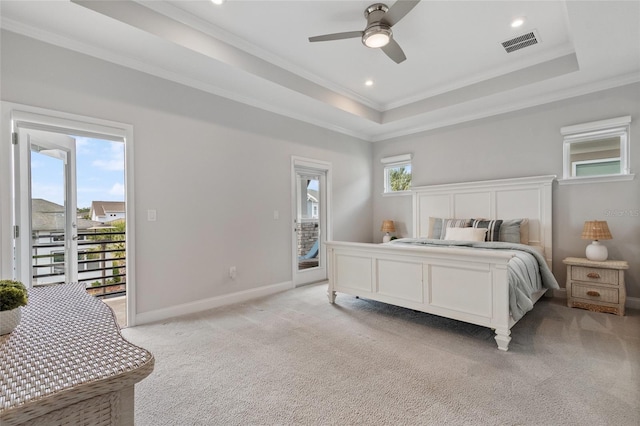 bedroom with light carpet, access to outside, a raised ceiling, and visible vents