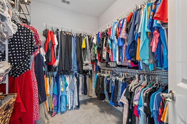 walk in closet with carpet floors and visible vents