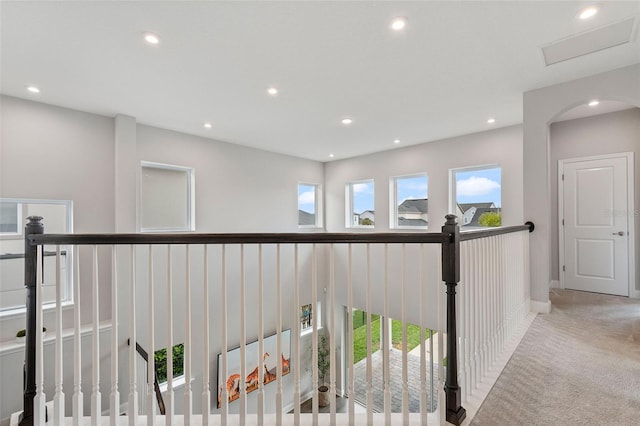 corridor with carpet floors, an upstairs landing, baseboards, and recessed lighting