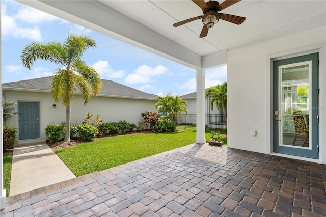 view of patio / terrace featuring ceiling fan and fence