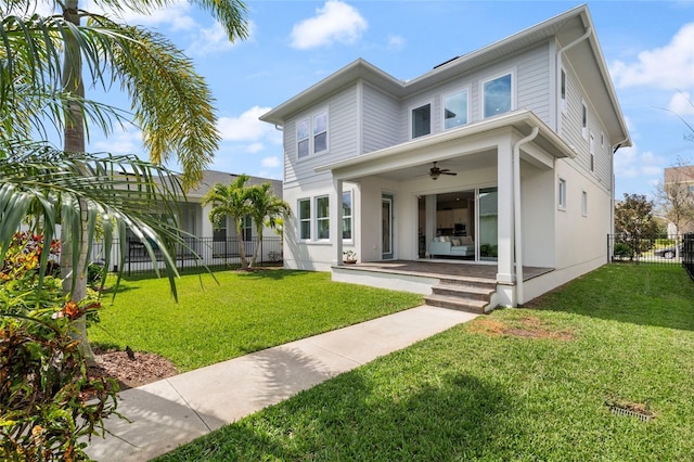 exterior space featuring a ceiling fan, fence, and a front lawn